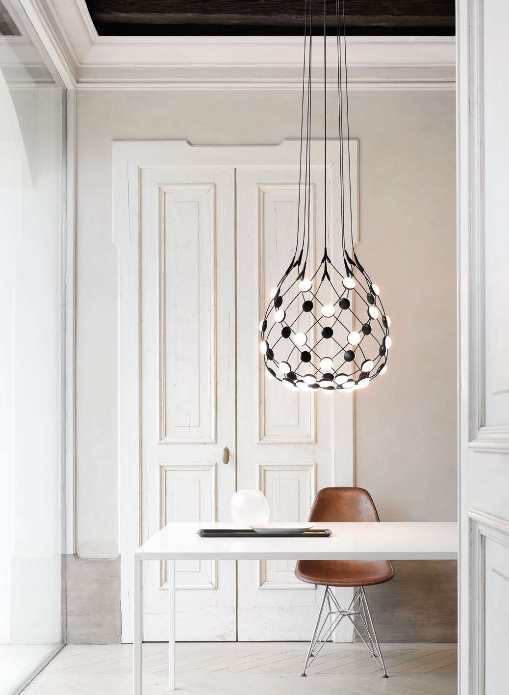 Luceplan Mesh suspension lamp over a dining table