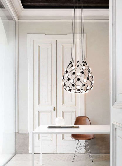 Luceplan Mesh suspension lamp over a dining table