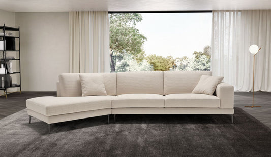 Cream fabric corner sectional sofa with chaise in a bright contemporary living room