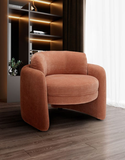 Ringo armchair in terracotta fabric in a contemporary living room with backlit shelving and sheer curtains
