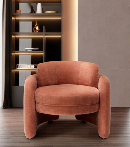 Front view of the Ringo armchair in terracotta fabric showing its round seat and curved enveloping arms