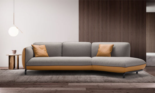 Rock sectional sofa in grey fabric with mustard leather base and cushions, shown in a modern living room with a wood slat wall