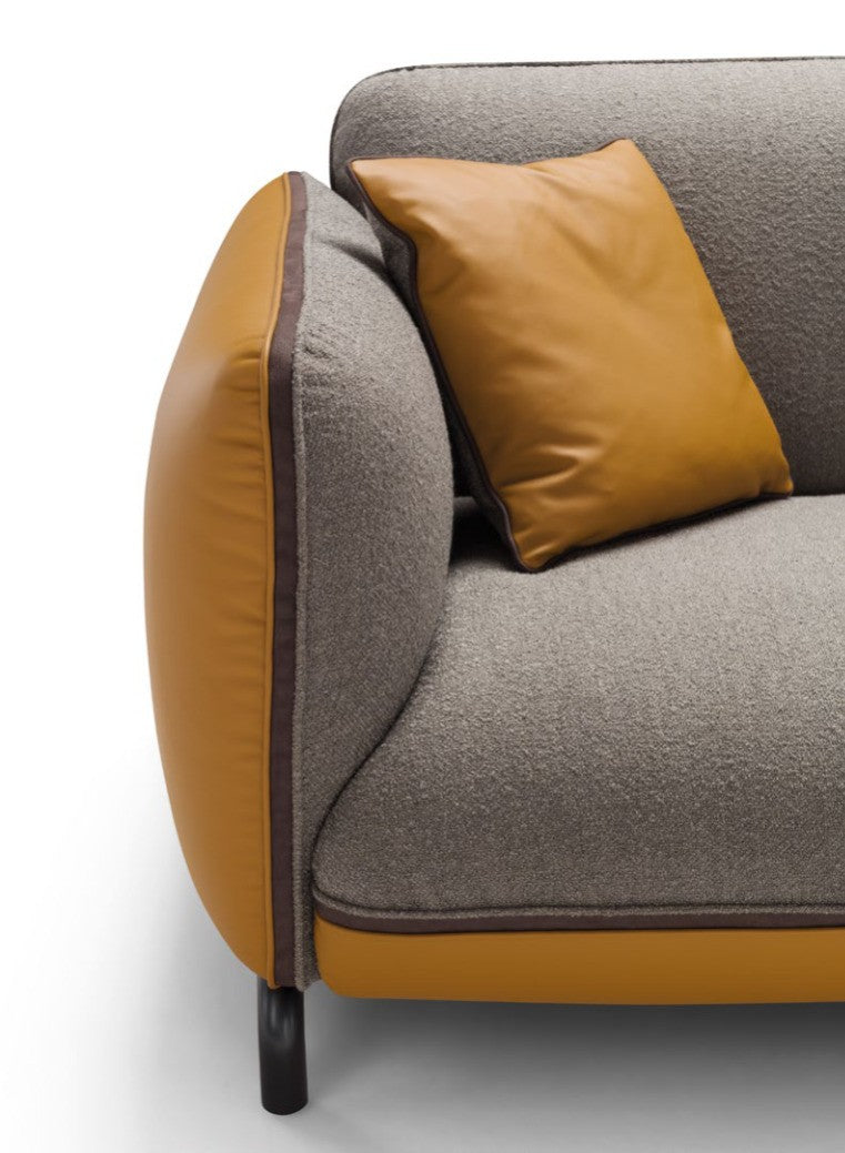Detail of Rock sofa armrest and back cushion showing mustard leather piping and contrast stitching