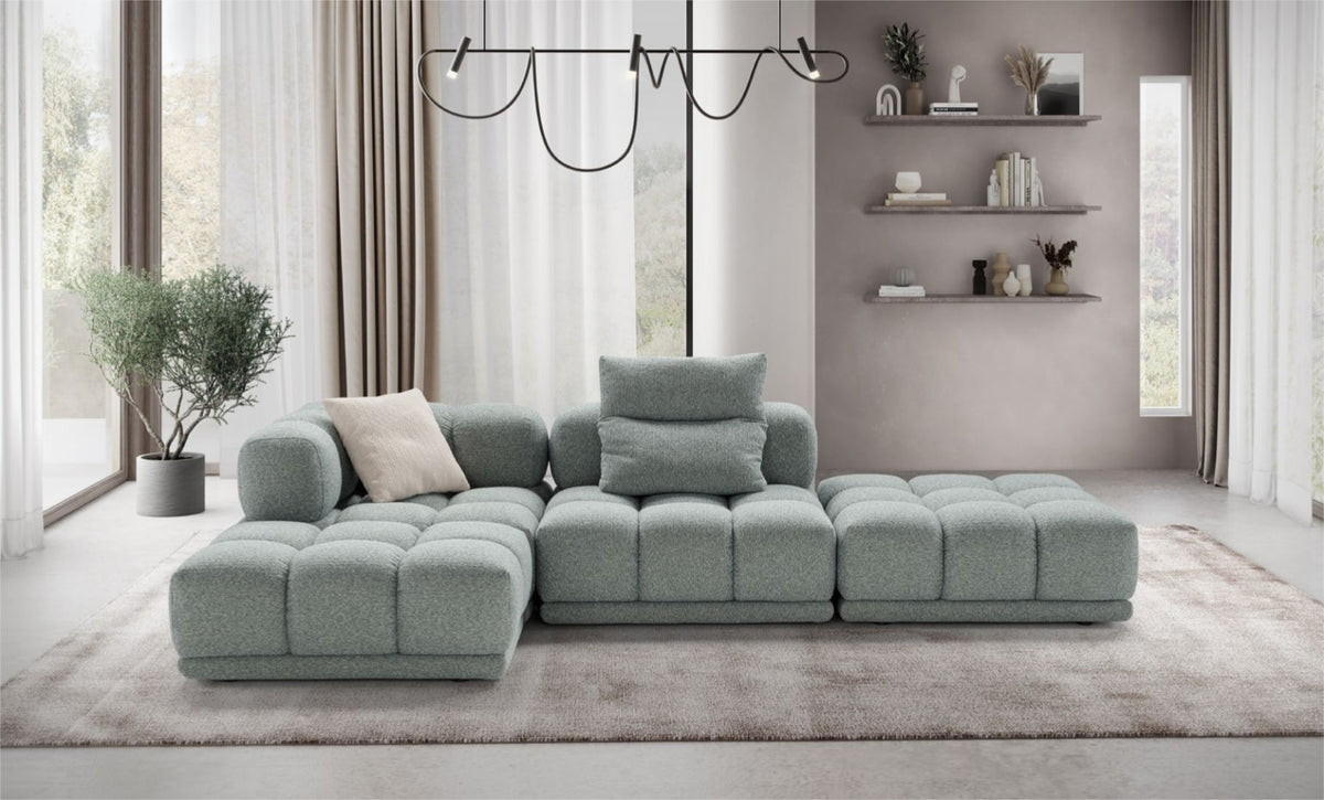Sacai modular sofa in sage-green fabric styled as an L-shaped sectional in a contemporary living room