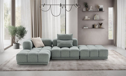 Sacai modular sofa in sage-green fabric styled as an L-shaped sectional in a contemporary living room