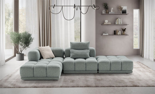 Sacai modular sofa in sage-green fabric styled as an L-shaped sectional in a contemporary living room