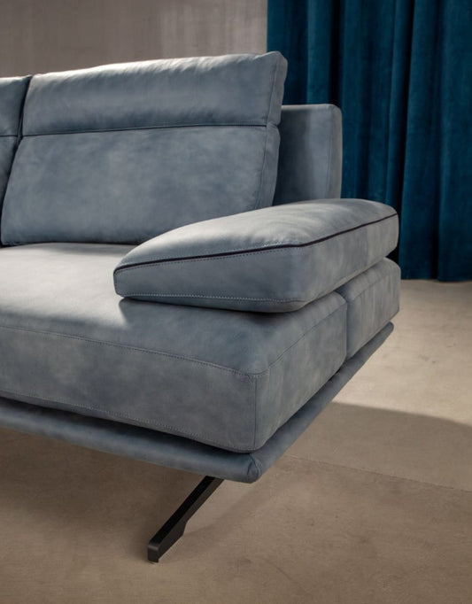 Close-up of quilted backrest, sliding armrest cushion and metal X-leg detail