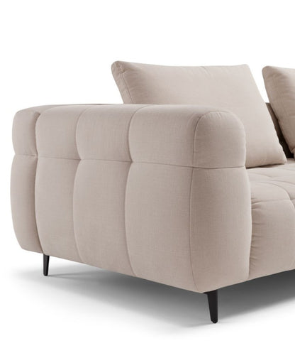 Close-up detail of the Sherry sofa's quilted armrest, back cushion and slim metal leg