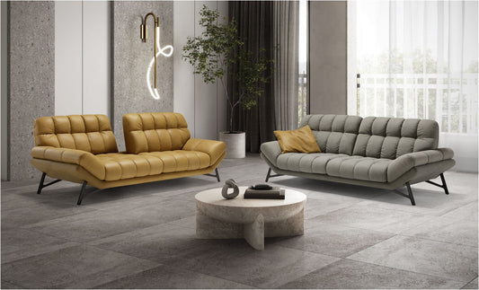 Spiga modular sofa in mustard leather with tilted backrests beside a grey fabric Spiga sofa in a bright living room