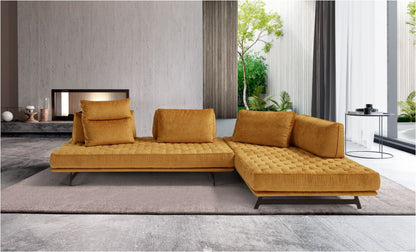 Stor sectional sofa in mustard yellow fabric with quilted seats and free-standing back cushions in a modern living room