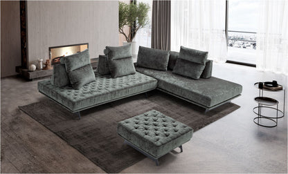Stor sectional sofa with matching ottoman in grey-green velvet, quilted platform base on metal sled feet, in a loft living room