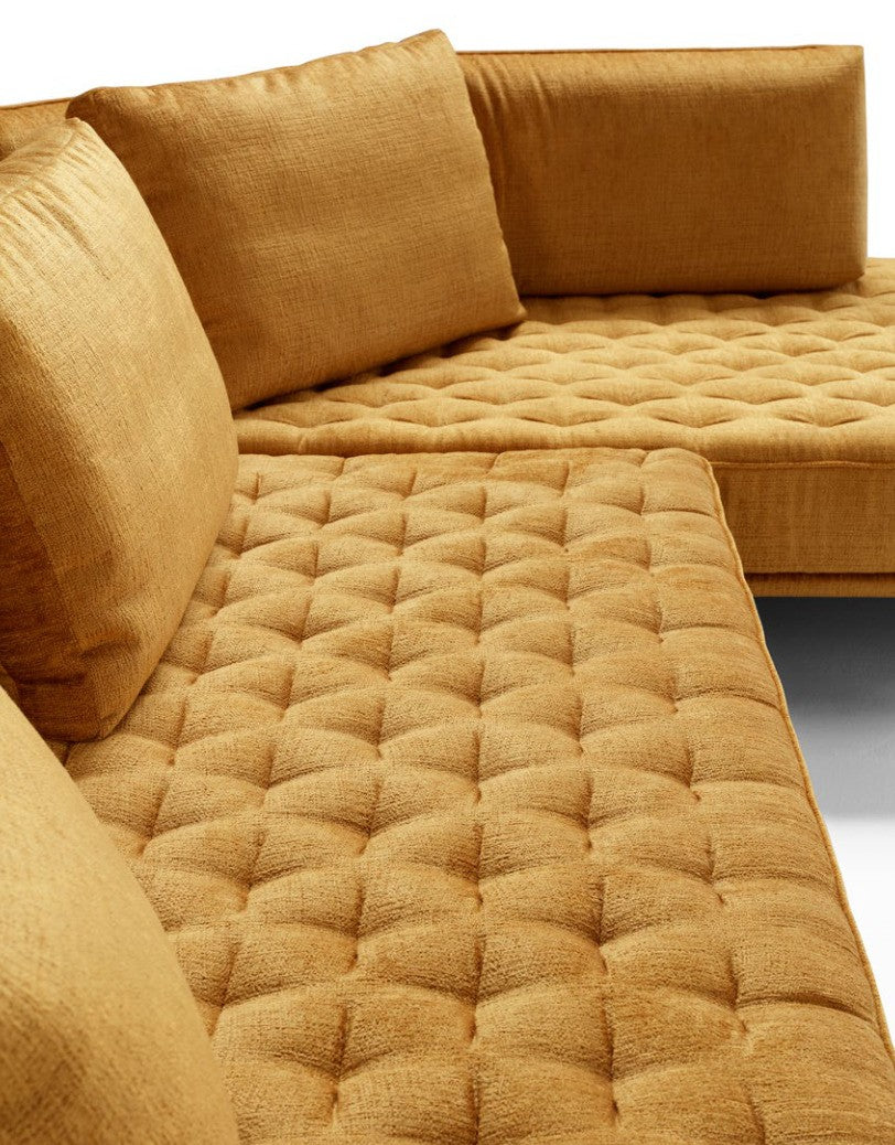 Close-up of the thick artisan quilting and back cushions of the Stor sectional sofa in mustard yellow fabric
