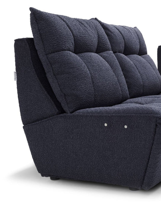Close-up of the Twin sofa's quilted back cushion, low armrest and electric recliner control buttons