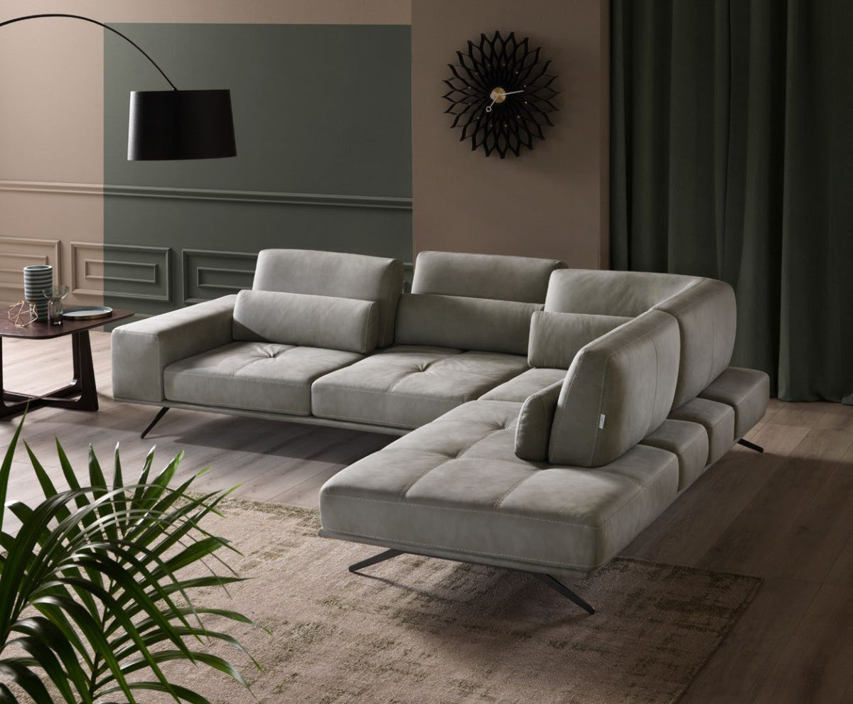 Angled view of the Vanoni sectional sofa with open-end chaise longue, lumbar cushions and black metal feet
