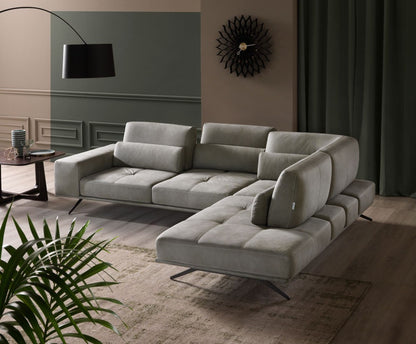 Angled view of the Vanoni sectional sofa with open-end chaise longue, lumbar cushions and black metal feet